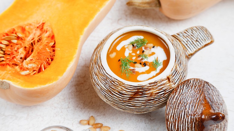 Decorative brown bowl with creamy butternut squash soup