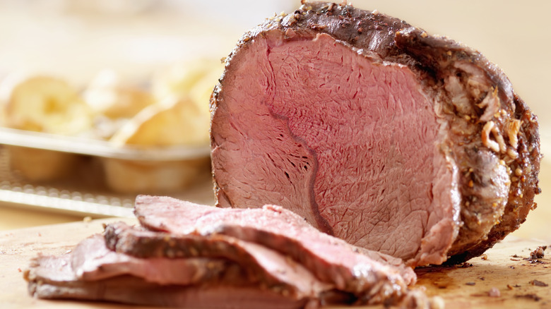 Sliced roast beef on board