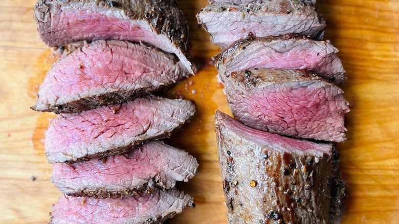 Two petite tender steaks cooked and sliced