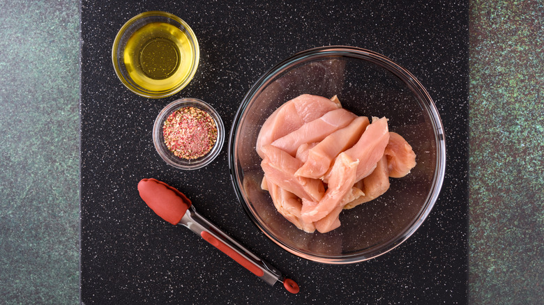 chicken breast pieces with oil and spices