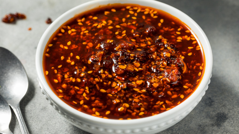 Fiery red chili crisp in a white bowl