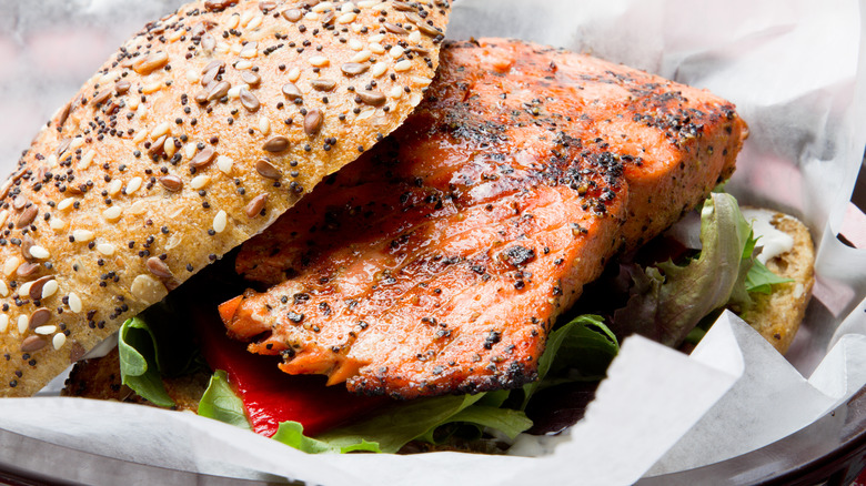 Grilled salmon sandwich on a seeded bun