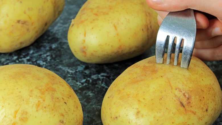 pricking fork holes in potatoes