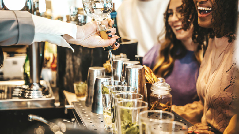 Bartender free pouring alcohol using a spout