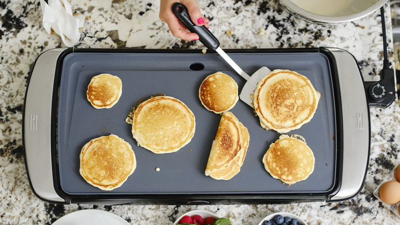 Pancakes cooking on a griddle 