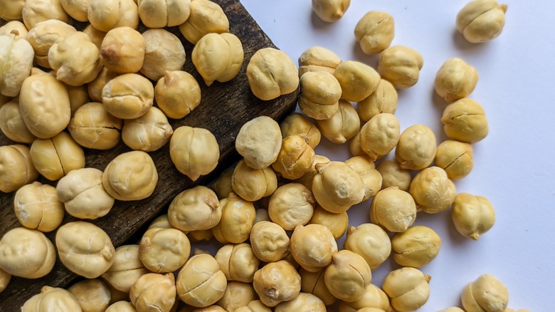 Dried chickpeas on a wooden board