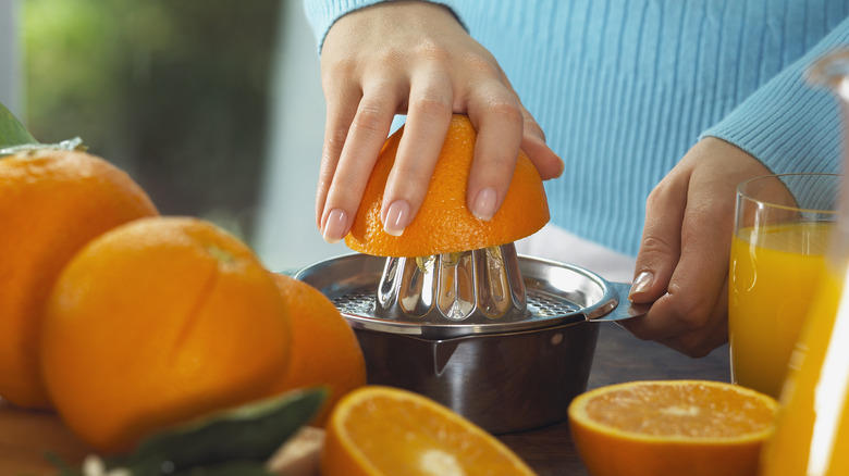 Person juicing orange 