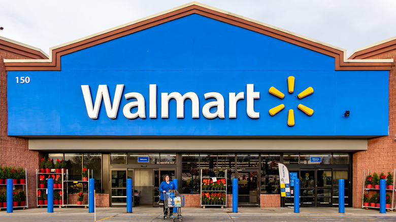 Woman exiting Walmart storefront