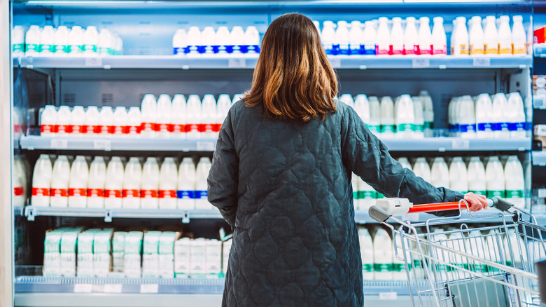 Woman looking at milk cooler