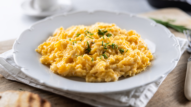 creamy scrambled eggs garnished with scallion