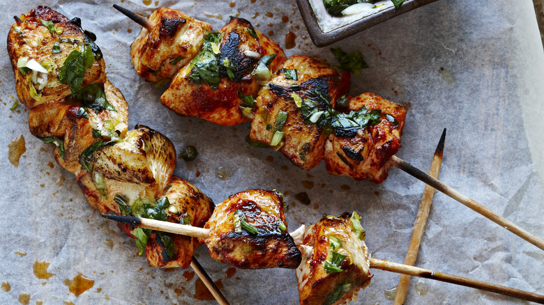 Chicken skewers on paper