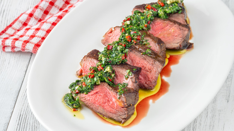 Steak and chimichurri served on a plate