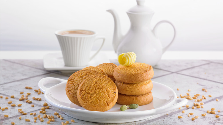 Plate of butter cookies next to teapot