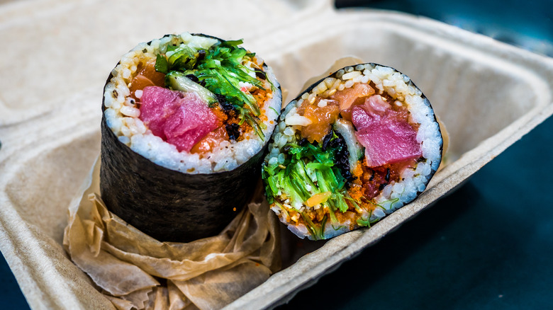 Sushi burrito in cardboard takeout box