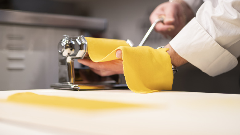 Rolling out a sheet of fresh pasta dough