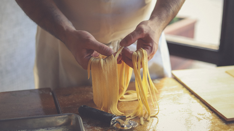 A person making fettuccine