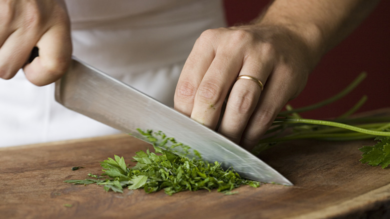 person chopping parsley
