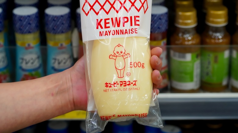 hand holding bottle of kewpie mayo