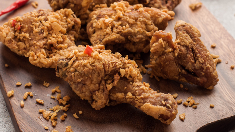 Spicy fried chicken on a cutting board