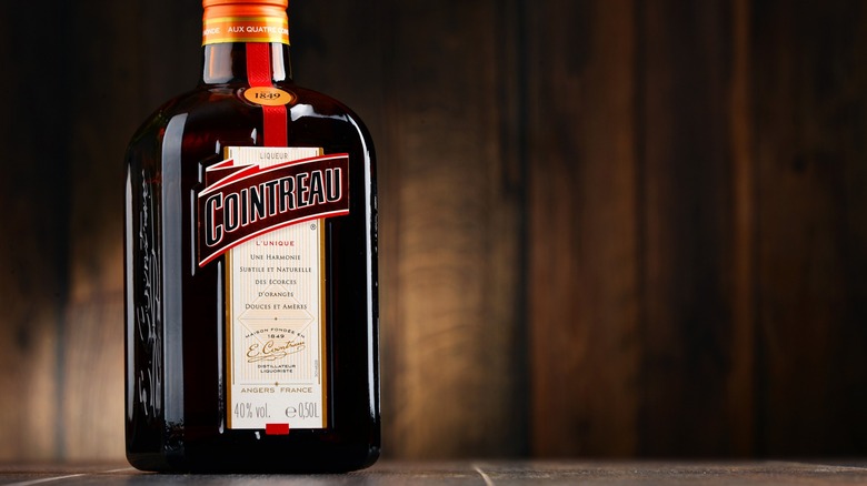 Cointreau liqueur bottle with wood background