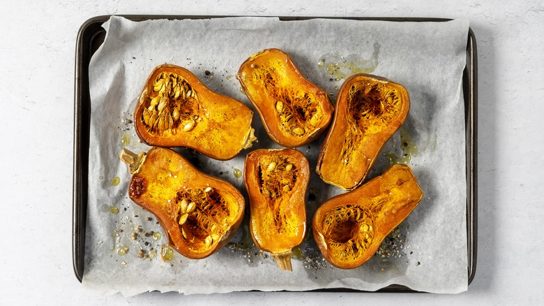 A tray of baked butternut squash halves