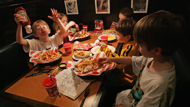 Kids enjoying fries and pizza at TGI Friday's