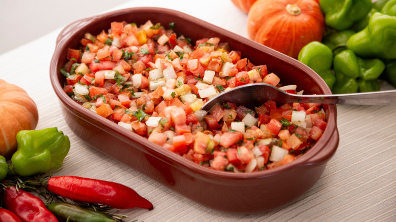 Tomato and onion vinagrete in a dish with a spoon