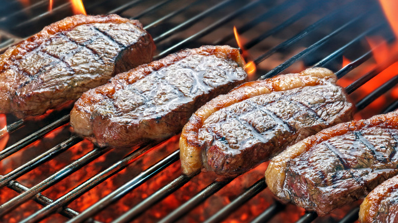 Picanha steaks cooking on a grill