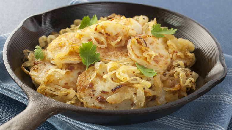 Lyonnaise potatoes in a cast iron skillet