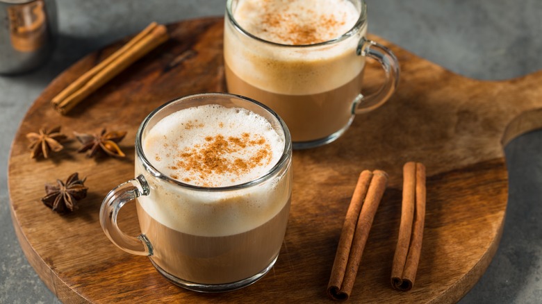 Two masala chai mugs with cinnamon sticks 