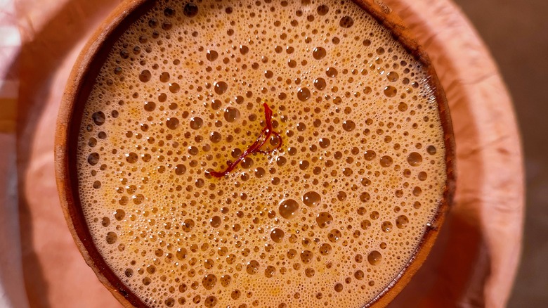 Close up of a saffron thread in a masala chai 
