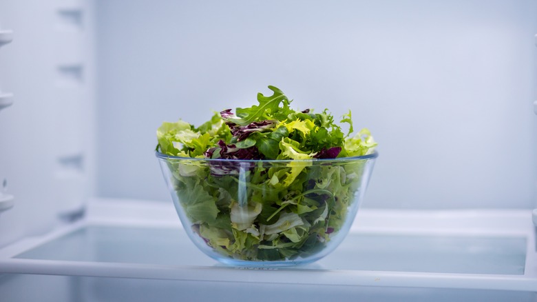 bowl of salad leaves in fridge