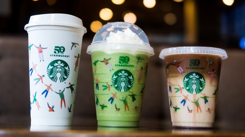 Three Starbucks beverages in to-go cups