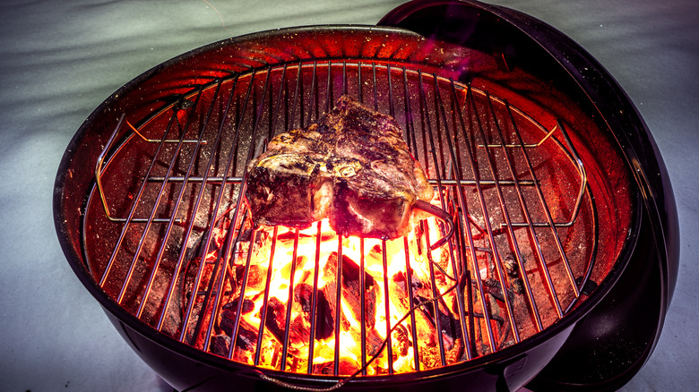 Weber Grill steak over coals