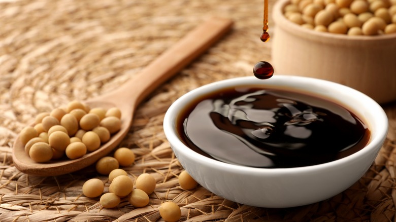 A bowl of soy sauce with soybeans