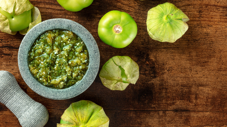 green salsa surrounded by tomatillos