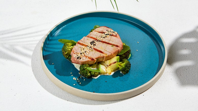 Grilled tuna steak on blue plate