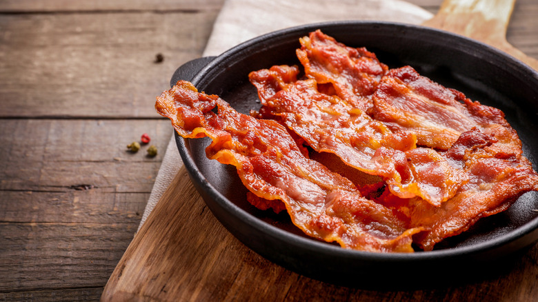 Crispy cooked bacon strips in a skillet