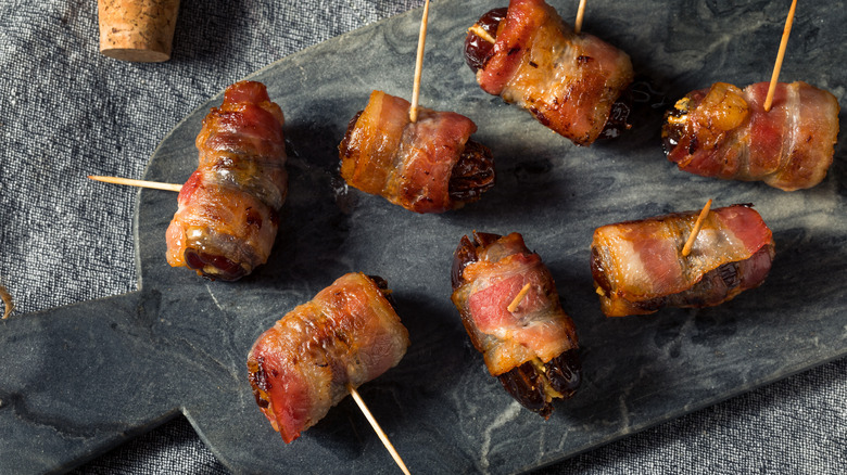 Bacon wrapped dates with toothpicks in the middle