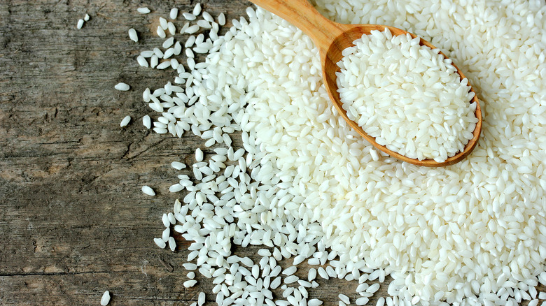 Wooden spoon with raw rice