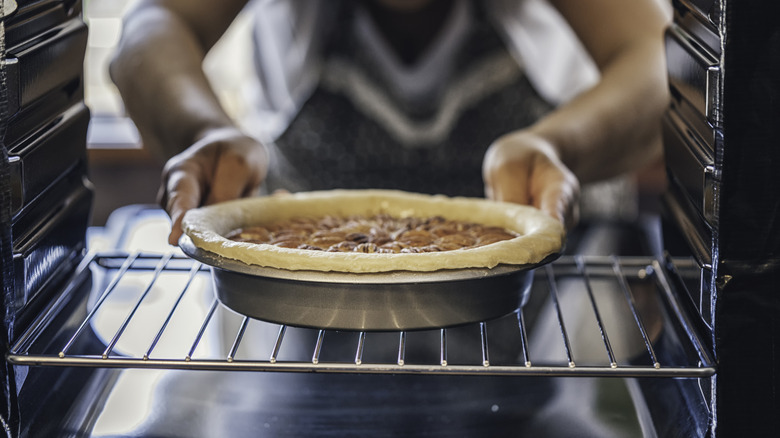 A pecan pie being pulled from the oven