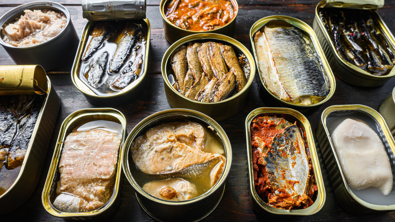 Tinned seafood on wooden table