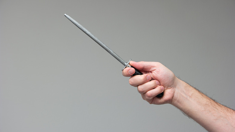 person holding honing rod