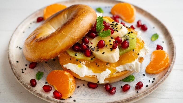 Toasted bagel with cream cheese, jam, and fruit