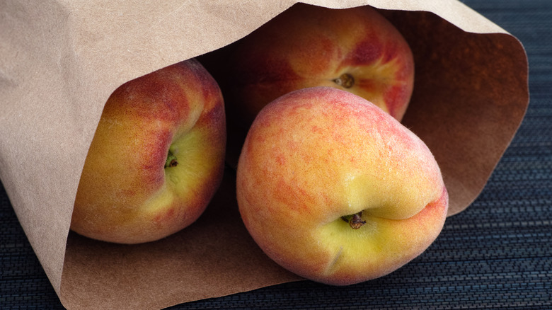 peaches in brown paper bag