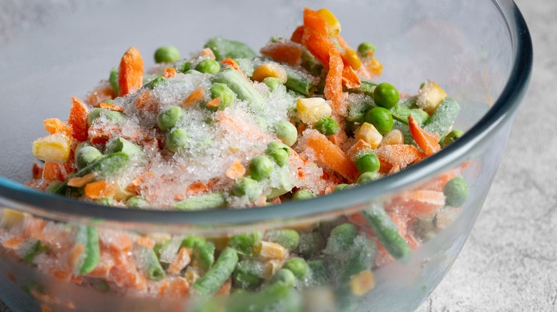 A bowl of frozen vegetables with ice crystals