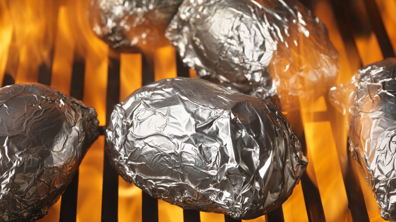Foil wrapped potatoes on grill