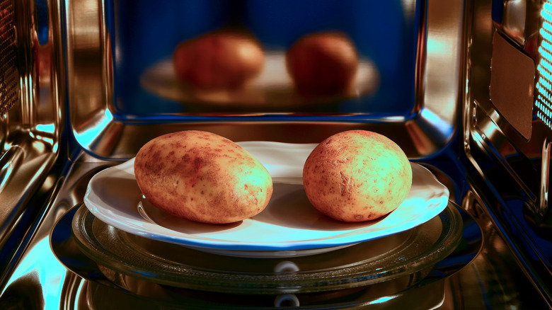 Two potatoes in microwave