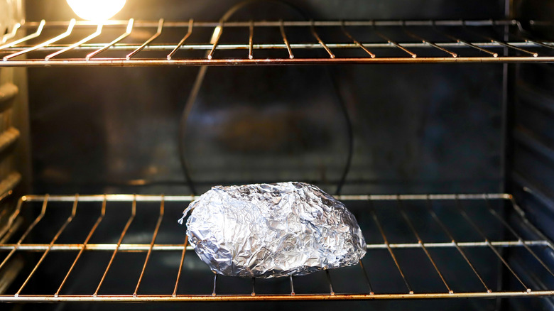 Foil wrapped potato in oven
