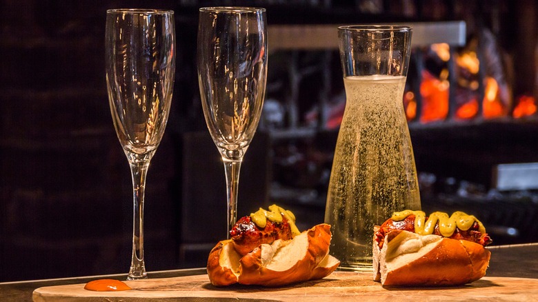 Sliced hot dogs with carafe of sparkling wine